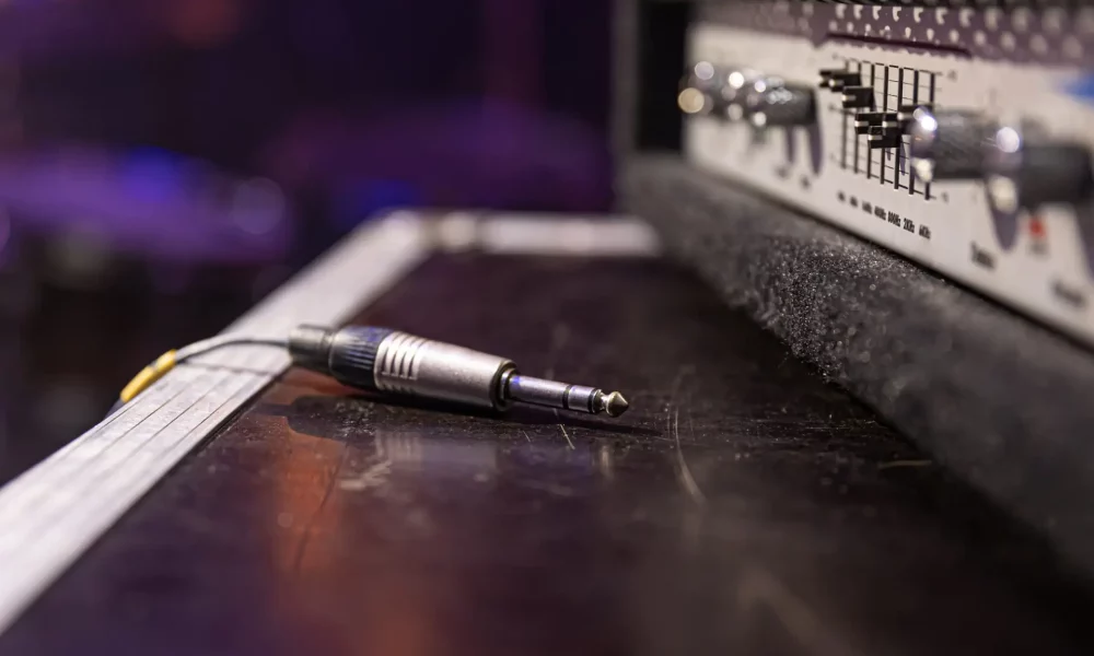 Jack audio connector being plugged into a socket on an audio device for music, audio.
